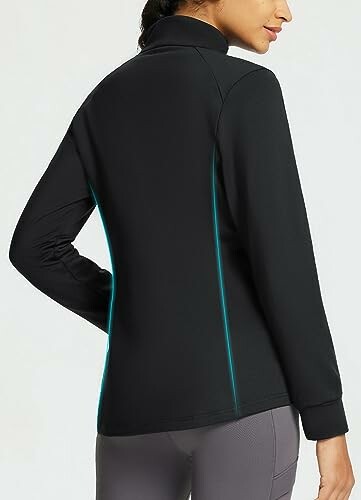 Woman wearing a black jacket, side view