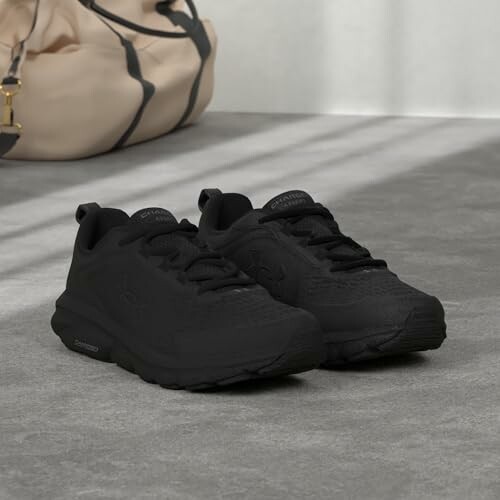 Black running shoes on a concrete floor