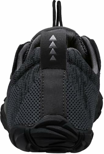 Back view of a black sport shoe with treaded sole and mesh fabric, highlighting the shoe's zero-drop sole