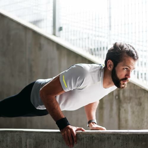 Man performing push-ups on concrete surface