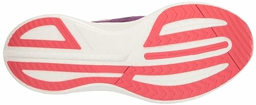 Bottom view of a running shoe with pink and white tread.