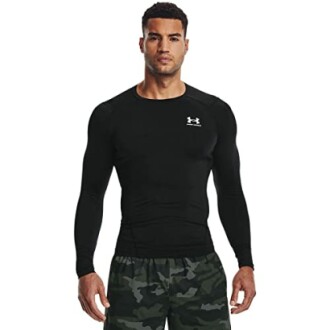 Man wearing a black Under Armour compression shirt and camo shorts.
